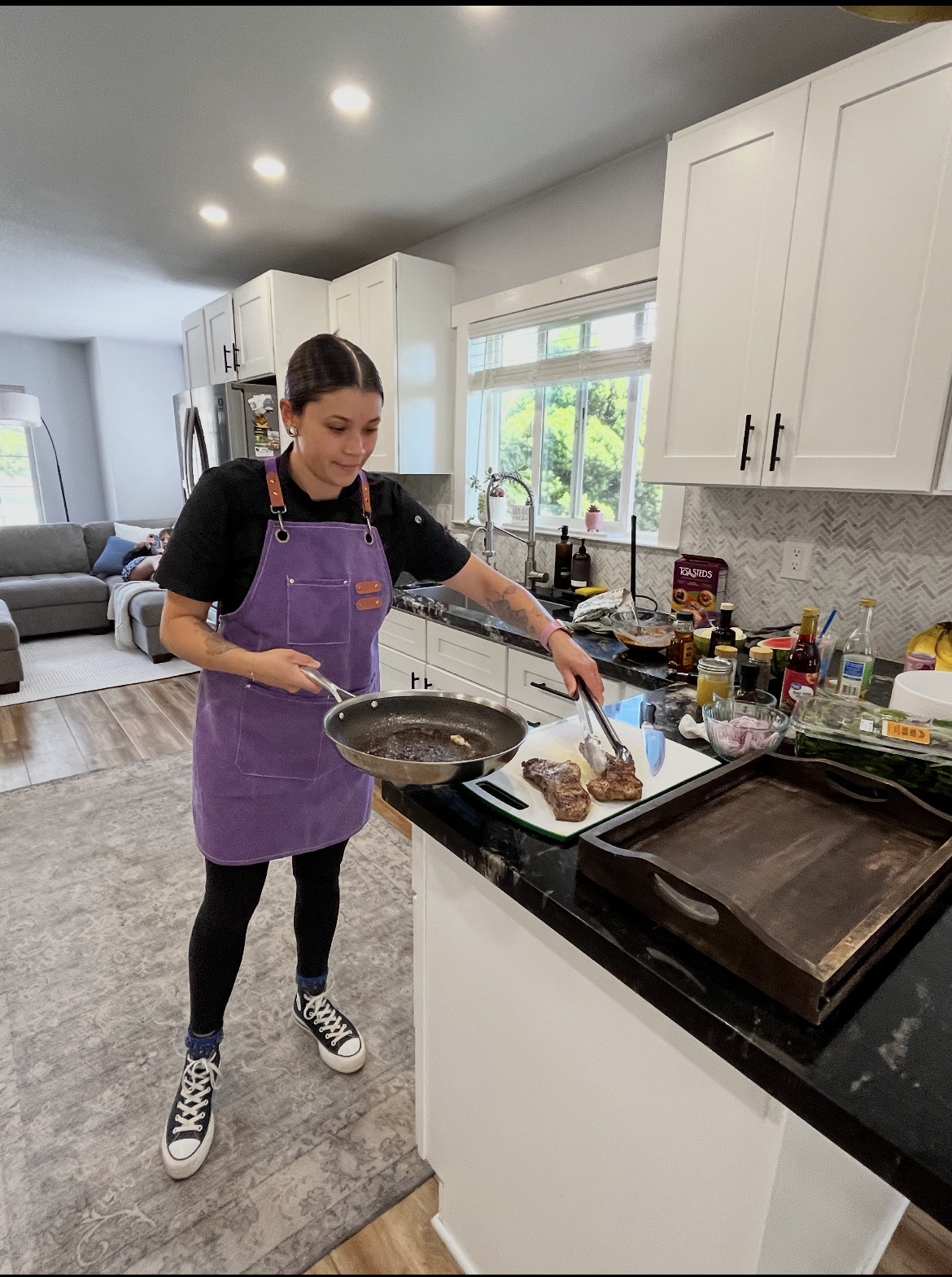 Chef Erika preparing steak in a private home kitchen